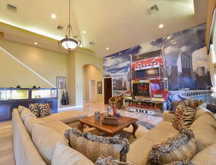 Living room inside Shaquille O'Neal's house, with a truck in the wall