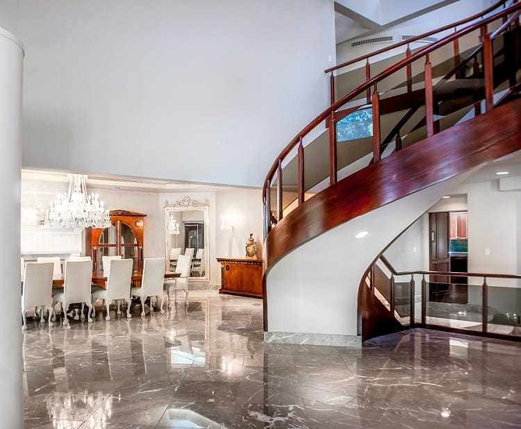 circular wood staircase with the formal dining table visible in the back