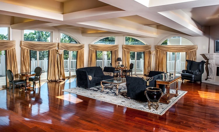 Living room with gold drapes over the windows inside 50 cent's house in connecticut 