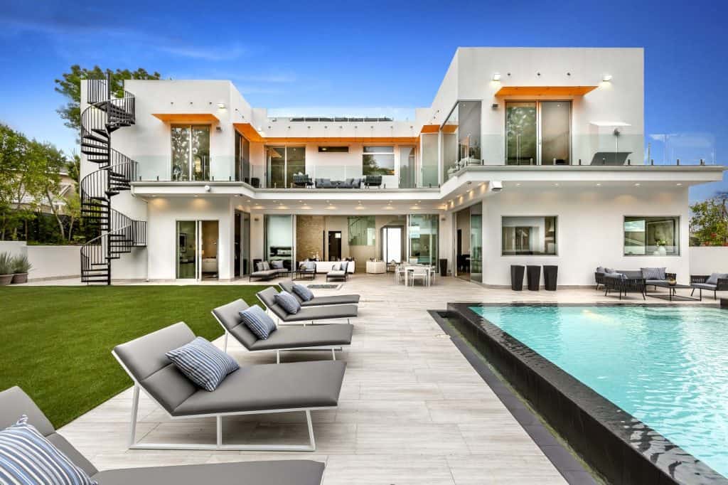 modern mansion with a pool in front 