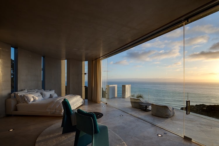 Bedroom with glass walls and ocean views inside Alicia Keys' house