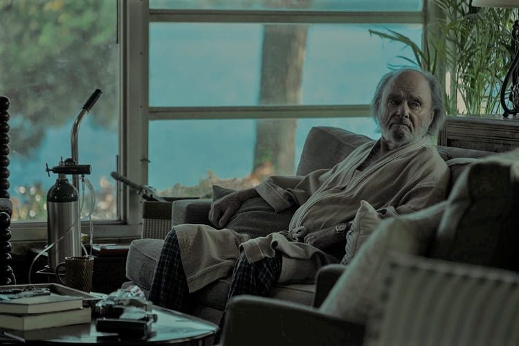 scene filmed inside the Byrde house in Ozark showing Buddy, the original resident of the lake house sitting on the sofa in his robe