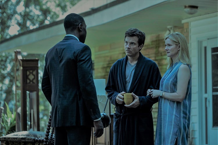 Marty Byrde (Jason Bateman) and his wife Wendy (Laura Linney) standing in front of their house in Ozark.