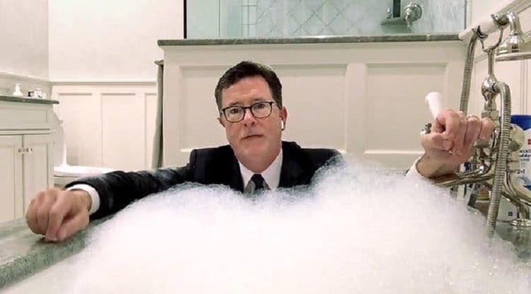 Colbert broadcasting from his house, filming a segment fully dressed in the bathtub