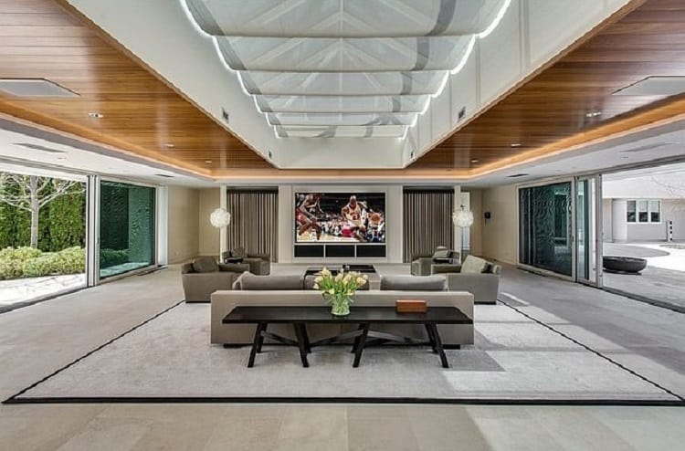 The living room has generous proportions and opens up to outdoor areas from both sides