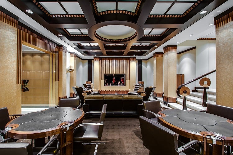 The cigar room brings all the drama with its intricate ceilings, moody decor, and stately columns