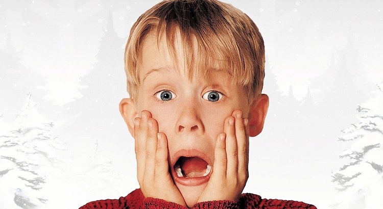 Macaulay Culking as Kevin McCallister on the poster for the first Home Alone movie, released in 1990.