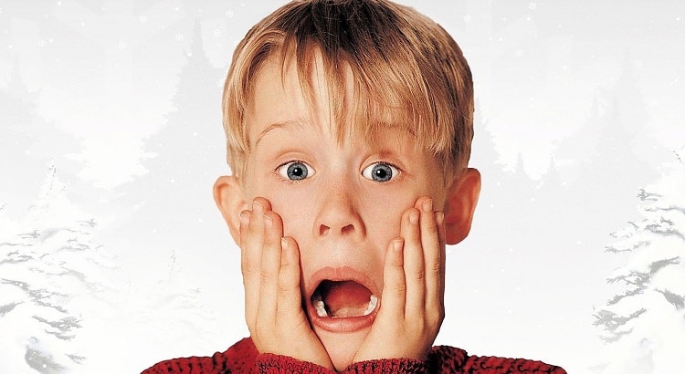 Macaulay Culking as Kevin McCallister on the poster for the first Home Alone movie, released in 1990. 