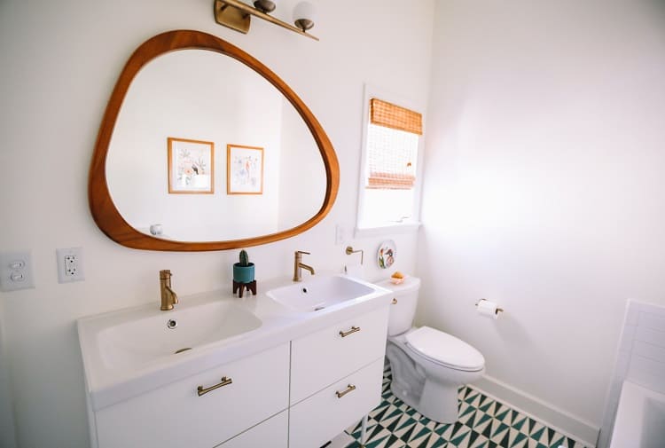 bathroom vanity with large, unique mirror