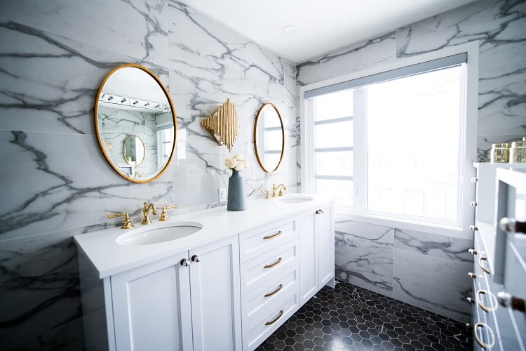 marble bathroom with gold fixtures