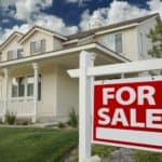 house for sale with sign in front