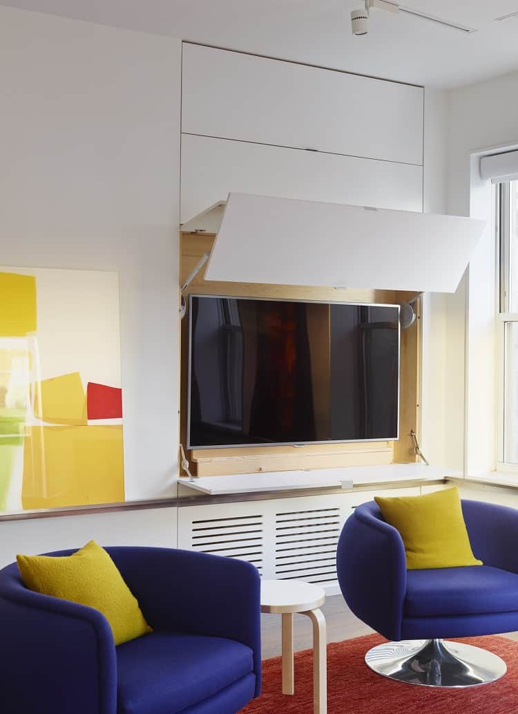 clever design hides the TV into the wall of the apartment