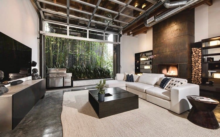 Modern loft in Venice, CA has a unique pull-up garage door window that opens to the outdoors. 