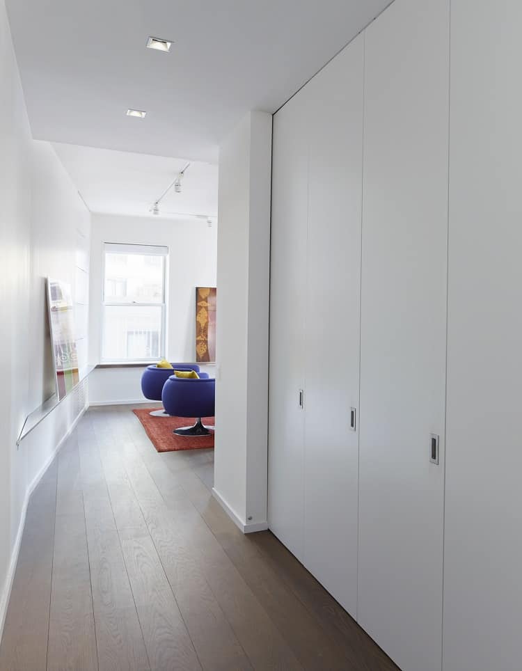 Sliding panels conceal the kitchen altogether