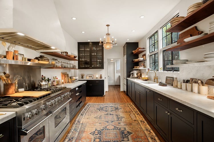 elegant kitchen with dark wood furniture and brass fixtures