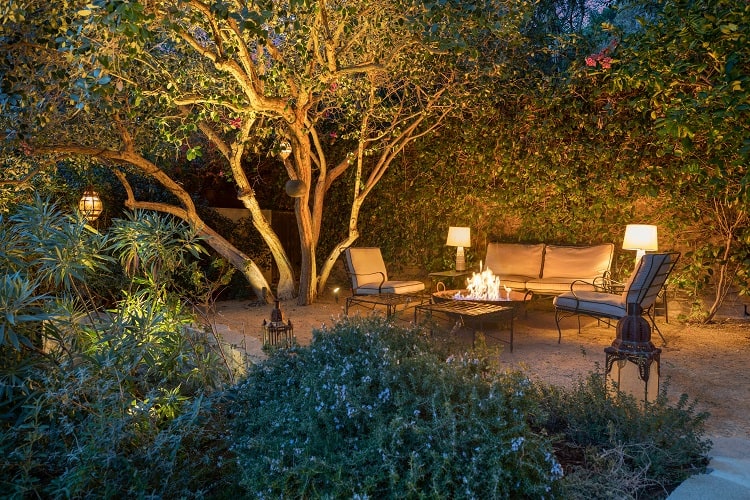 The quiet, private backyard has several seating areas, including one set around a fire pit. 