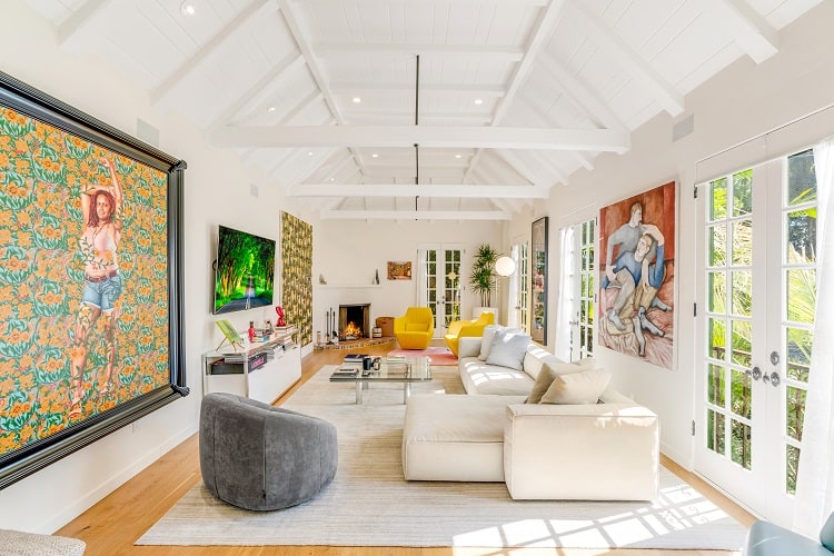 bright, art-filled living room with soaring ceilings
