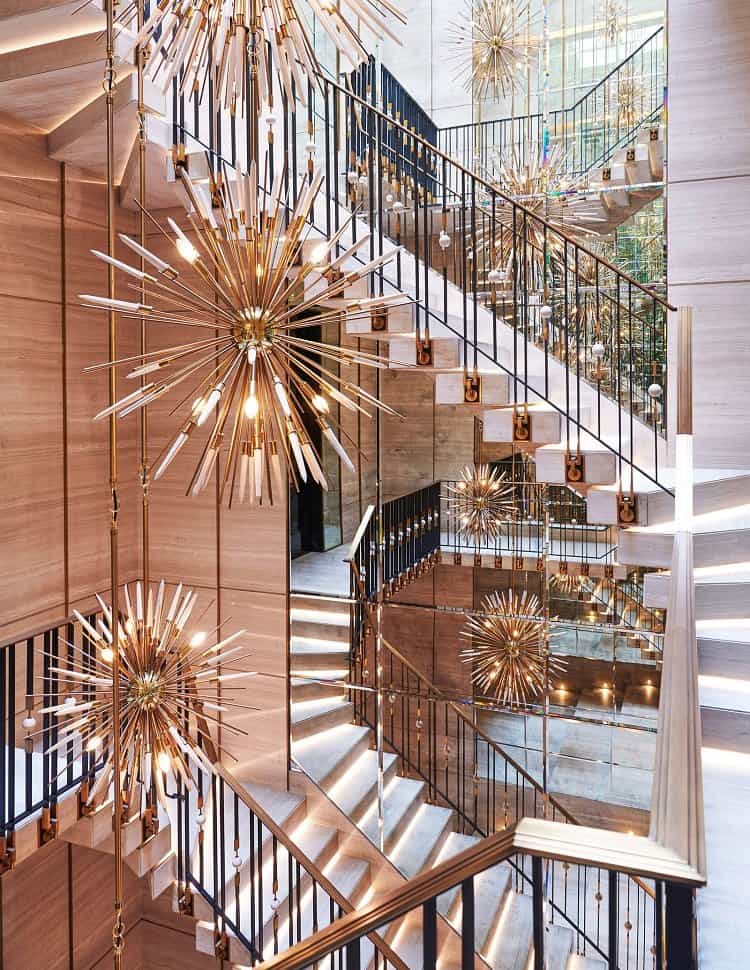 Chandeliers lining up the suspended marble staircase in Drake