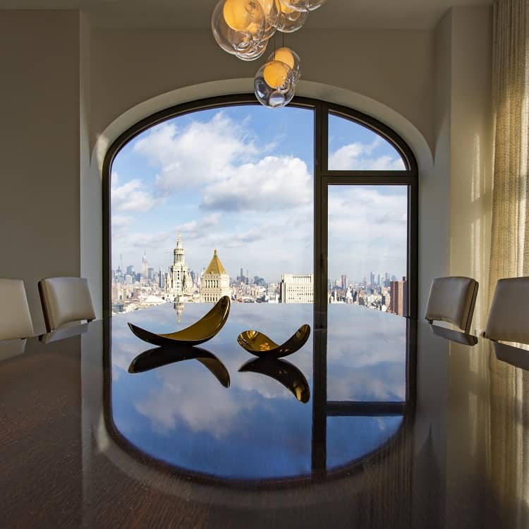 city views from the dining room of an apartment inside 130 William Street in New York City