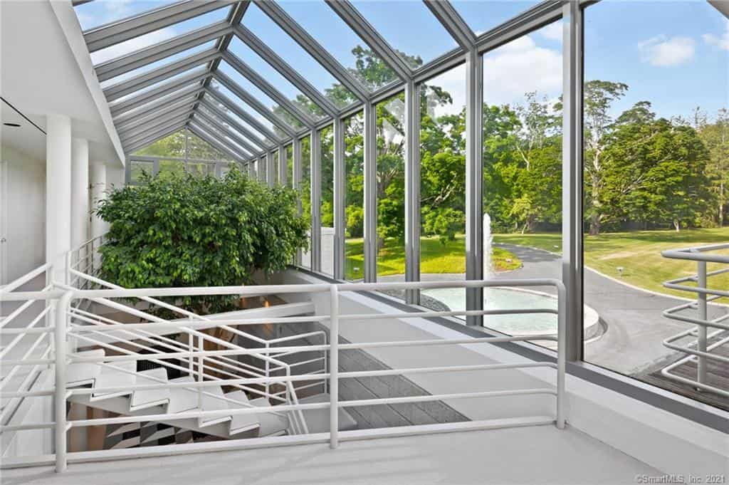 the atrium of the morris house has a tree planted in it 