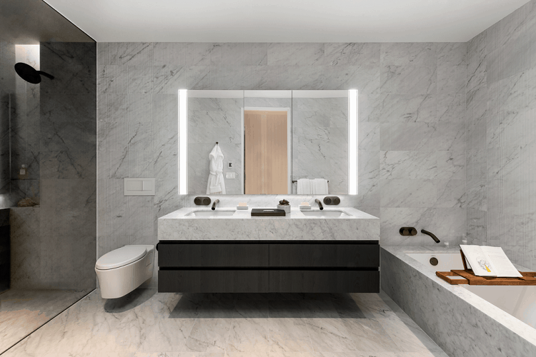 130 William Street bathroom, dressed in Italian marble and featuring walk-in showers