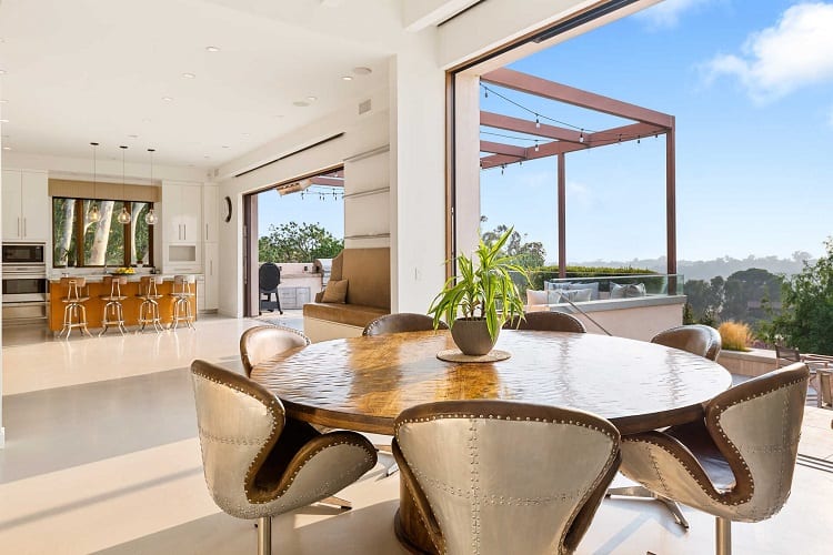 kitchen and dining room with large sliding doors that open up to the outdoor entertaining area