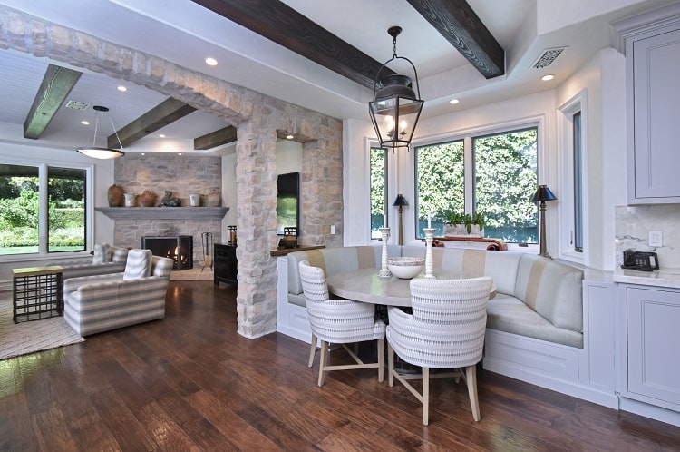 lovely kitchen nook leading to an inviting living area with fireplace