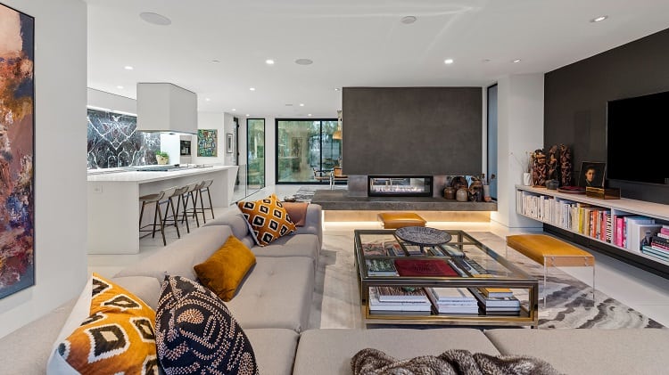 luxurious modern living room with an open floor plan and a floor-to-ceiling fireplace