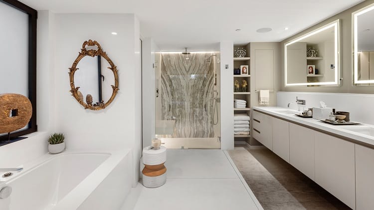 To complete the retreat-like setting, the bedroom leads into an open spa-like bathroom which features a gold tinted mirror.