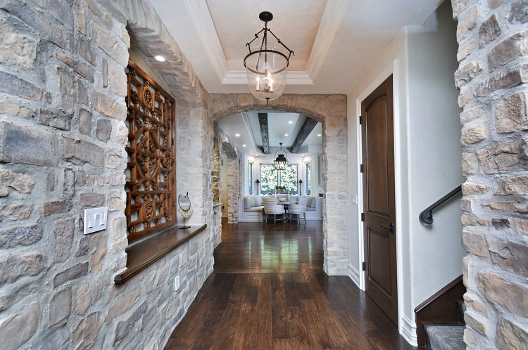 hallways with walls of stone and beautiful wood floors