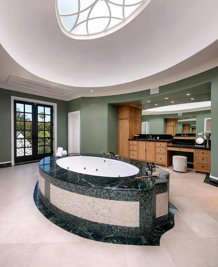 bathroom with stone soaking tub and a skylight