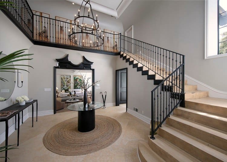 elegant entrance with a chandelier and staircase