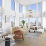 a light-filled penthouse living room with tall ceilings and double-height windows