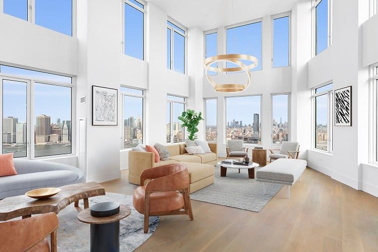 a light-filled penthouse living room with tall ceilings and double-height windows