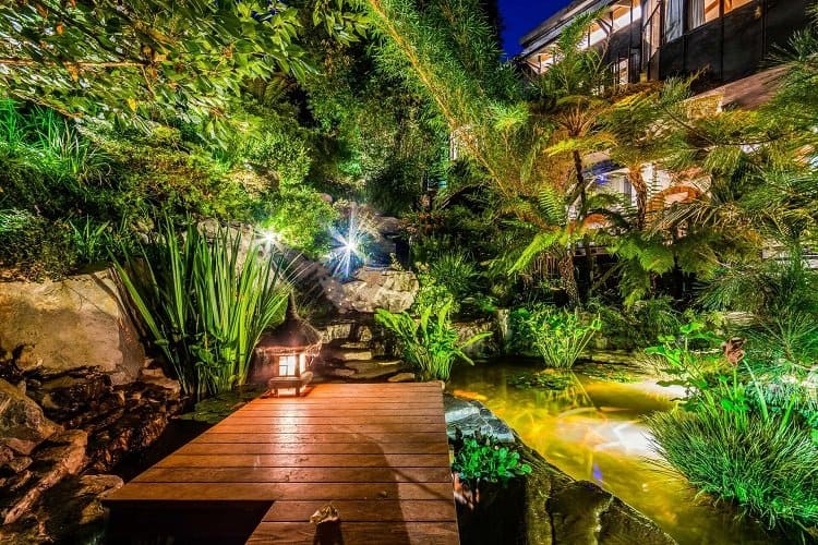 Tommy Lee's house has magical pathways, gardens of bamboo and fern trees, and a Koi pond.