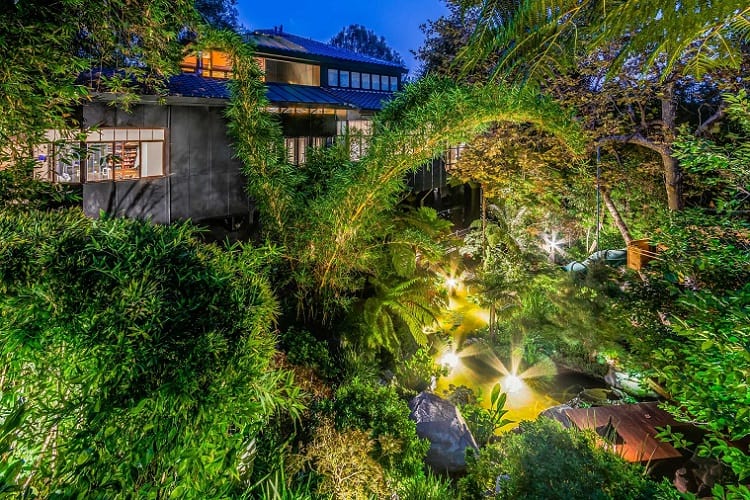 Tommy Lee's new house has unique outdoor features, including magical pathways, gardens of bamboo and fern trees, and a Koi pond.