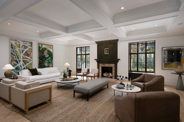 ultra-elegant living room with coffered ceiling and wood-carved fireplace