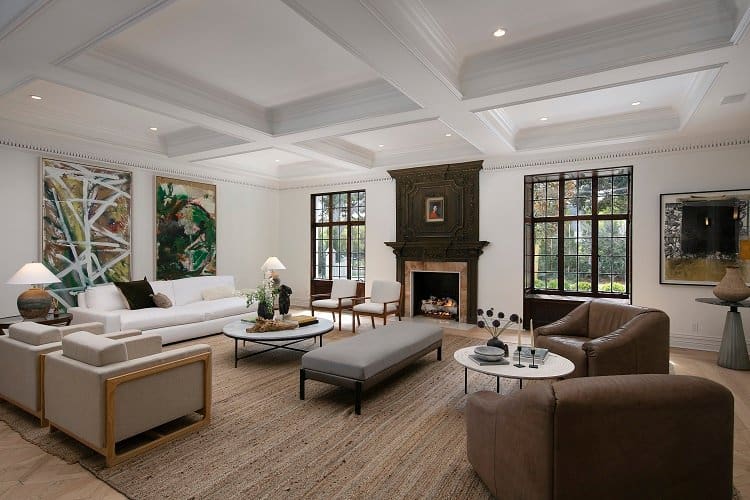 ultra-elegant living room with coffered ceiling and wood-carved fireplace 