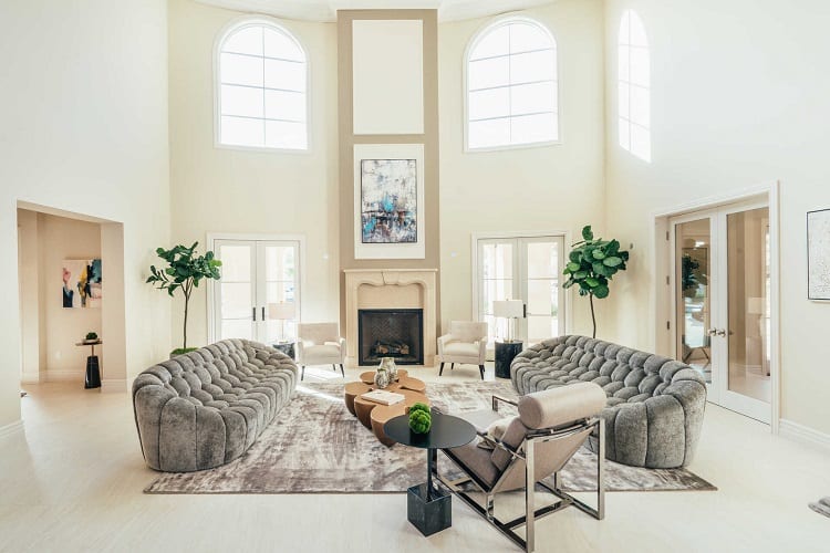 The living area has tall ceilings and double windows that bring in plenty of natural light.
