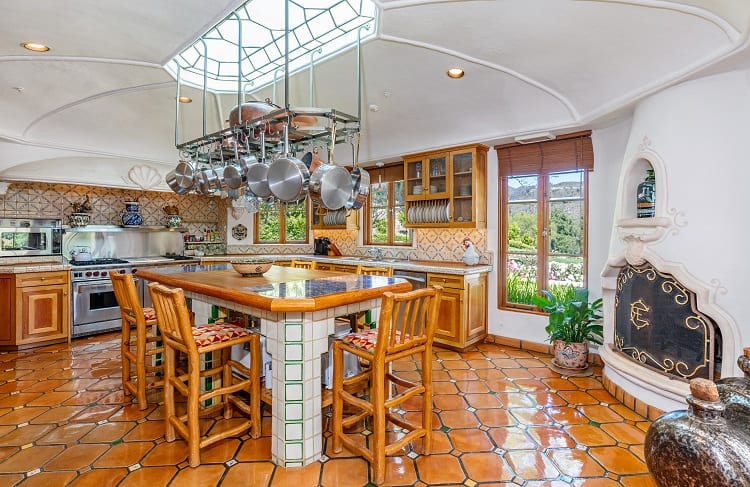 rustic kitchen with wood furniture, skylight, and tiles