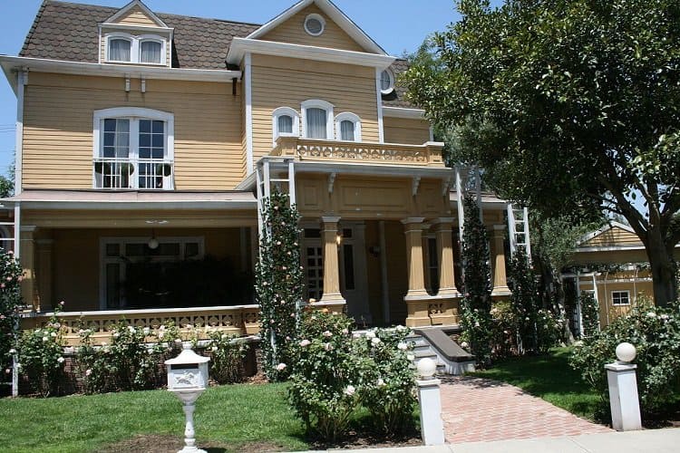 the exterior of Gaby Solis' house on Desperate Housewives, a three-story traditional home with light brown exteriors 