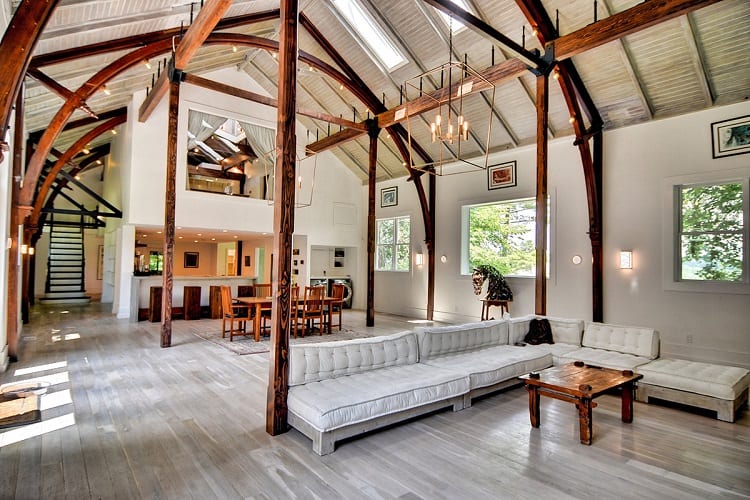 inside the Playhouse vacation rental, which has a wooden beam structure and bright, open living area