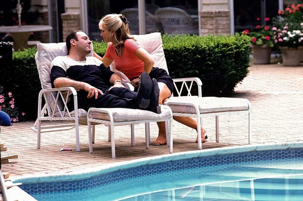 Tony Soprano and his wife sitting next to the pool of the Sopranos house