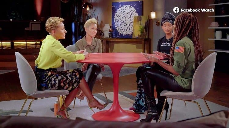 scene from Jada and Willow Smith's Red Table Talk show, with the cast standing around a red table inside Jada and Will Smith's house in Calabasas