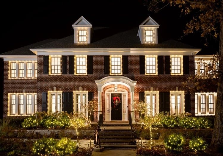 exterior of the Home Alone house, a two-story brick colonial draped in Christmas lights