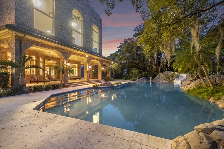 The notorious estate has countless amenities, including a pool with slide and waterfall, a racquetball court, indoor basketball court, vintage movie theater, and a massive open floor game room. 