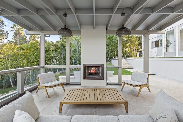 Outdoor seating with fireplace in François and Brandy Navarre's house in Pacific Palisades