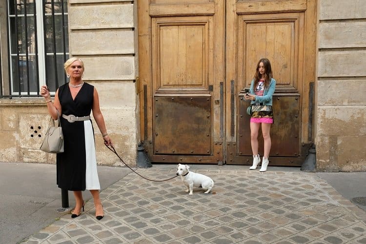 LILY COLLINS standing in front of Emily's apartment in EMILY IN PARIS.