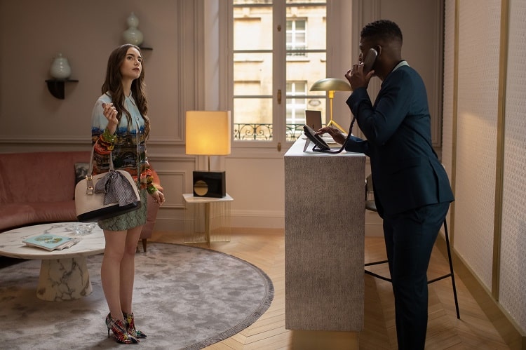  LILY COLLINS as EMILY and SAMUEL ARNOLD as LUKE at the Savoir office in EMILY IN PARIS