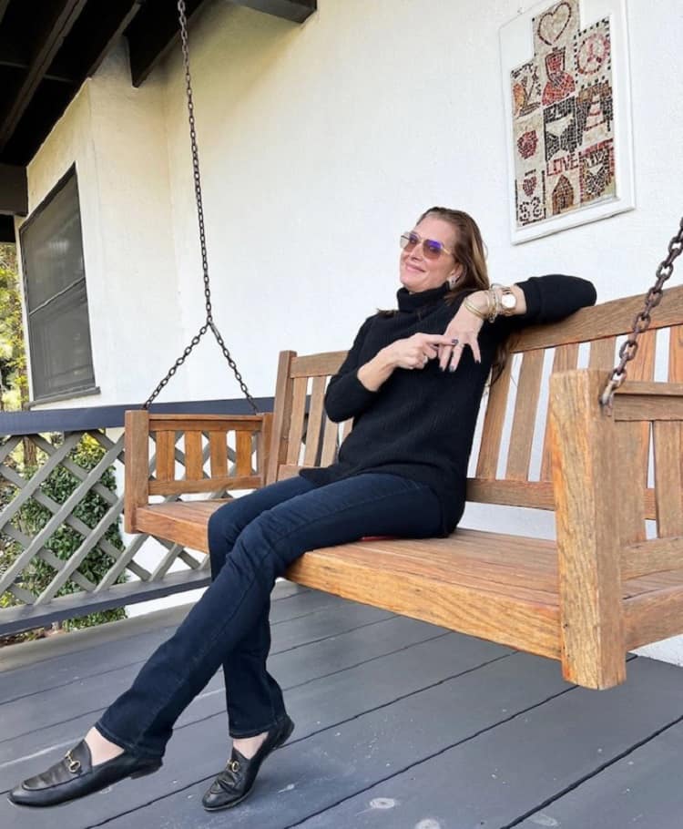 Brooke Shields sitting on the porch of the house she sold in Los Angeles. 